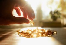 Mystery of Untapped Vitamin D Benefits A hand reaching for a golden capsule among many on a table