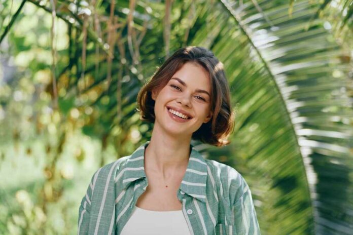 Smiling,Woman,Outdoors,In,Natural,Light,,Wearing,A,Striped,Green