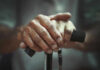 Hidden Strength Tests Predict Longevity Close-up of elderly hands resting on a walking cane