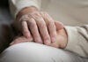 Two hands gently resting on each other, symbolizing care and connection