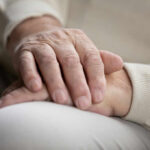 Two hands gently resting on each other, symbolizing care and connection