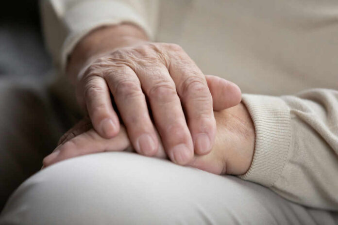 Two hands gently resting on each other, symbolizing care and connection