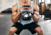 Why Your Squats Aren’t Building Muscle Athlete performing a kettlebell squat in a gym