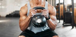 Athlete performing a kettlebell squat in a gym