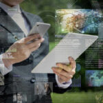 Business professional using a smartphone while surrounded by digital news articles and data visualizations