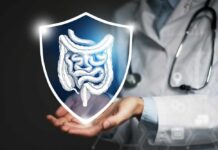 A doctor holding a digital shield with a graphic of the digestive system