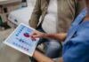 Hidden Cholesterol Number Doubles Stroke Risk Nurse showing a patient health data on a tablet