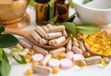 Vitamin B2: Cancer’s Unexpected Ally Various herbal supplements and vitamins arranged with leaves and a mortar