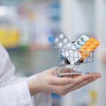 MIRACLE Migraine Drug: Unexpected Blindness Shield! A doctor holding a miniature shopping cart filled with various medication packs