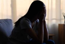 ‘Self-Improvement’ Craze Quietly Wrecks Health A silhouette of a person sitting with their head in their hands, conveying distress