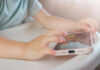 Algorithm Trap Targets Young Fragile Girls Childs hands interacting with a tablet on a table