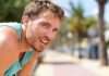 man in athletic tank top resting outdoors