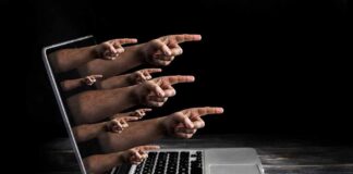 Laptop with multiple hands pointing from the screen