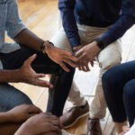 A group of people engaged in a discussion with hands gesturing expressively