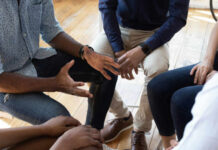 Celebrity Confession Flips HIV Stigma A group of people engaged in a discussion with hands gesturing expressively