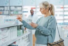 Woman shopping for medicine in a pharmacy aisle