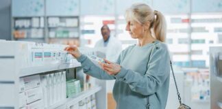 Woman shopping for medicine in a pharmacy aisle