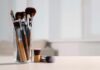 E. Coli On Your Face? Dermatologists Sound Alarm A collection of makeup brushes in a glass container on a table