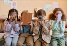 Psychogenic Epidemic: Smartphones Draining Purpose Four children sitting together, each engaged with their electronic devices