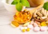 Beta-carotene: Sun Shield Or Cancer Risk? Assorted vitamins and supplements arranged with mint leaves