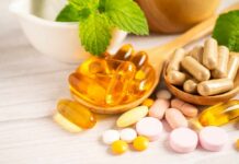 Assorted vitamins and supplements arranged with mint leaves