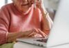 Longevity Clue Hiding In Your Blood Elderly woman on a phone call while using a laptop