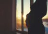 Second Baby, Different Brain Wiring Silhouette of a pregnant woman standing by a window at sunset