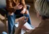 Global Mental Health Crisis—Shocking Numbers! Two individuals engaged in a conversation during a counseling session