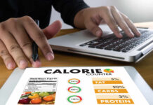High-sugar diets impact on your brain health Person using a calorie counter app on a tablet while working on a laptop