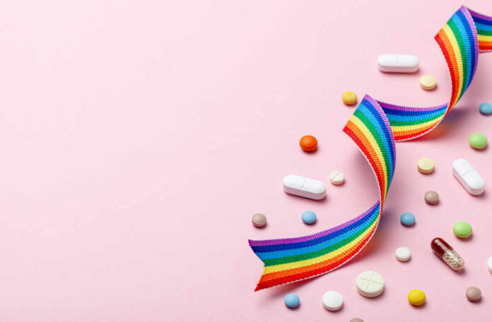 Hormone,Pills,After,Sex,Change.,Transgender,Transition.,Pride,Lgbt,Rainbow Colorful pills and a rainbow ribbon on a pink background