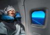 Massive study turns snoring into a brain warning A passenger sleeping on an airplane with headphones and an eye mask