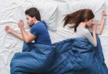 Snoring Wrecks Marriages — Remedies, Devices, and Cure Couple sleeping back to back in bed under blue blanket