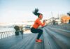Woman exercising on outdoor steps by a riverside