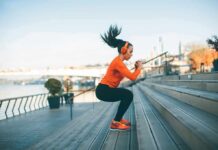 Woman exercising on outdoor steps by a riverside