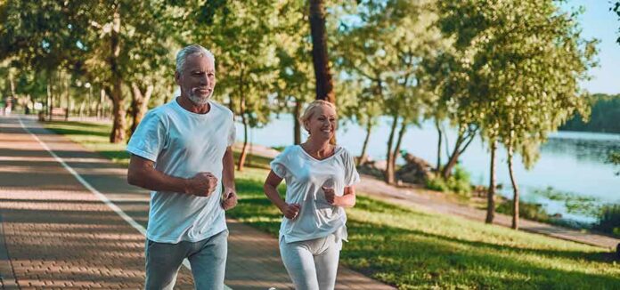 shutterstock_1191418468 Older couple jogging on a lakeside path