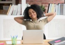 Woman relaxing at desk with laptop