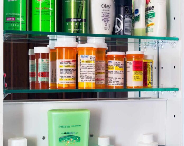 shutterstock_1643578801 Medicine cabinet with prescription bottles and toiletries