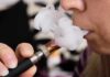 Sweet Vapes, Scary DNA Signals Close-up of a person vaping, exhaling smoke clouds