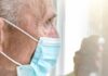 Midday Sun: Big Gains, Bigger Risks Older man wearing a surgical mask looking out a window