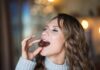Your Sweet Tooth Could Actually Be Beneficial For Your Brain Woman eating a chocolate truffle