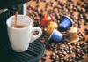 Coffee Label Lies Exposed Espresso machine pouring coffee into a white cup with coffee pods and beans