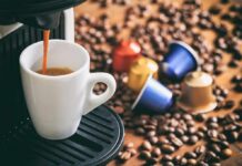 Coffee Label Lies Exposed Espresso machine pouring coffee into a white cup with coffee pods and beans