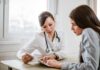 Doctor consulting a patient at a desk