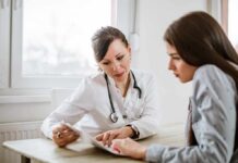 Health Insurance Playbook: The Copay Bill Doctor consulting a patient at a desk