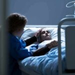 Cancer Diagnosis Triggers Sudden Stroke Spike Patient in hospital bed with visitor holding their hand