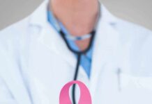 Doctor holding stethoscope with pink ribbon in front