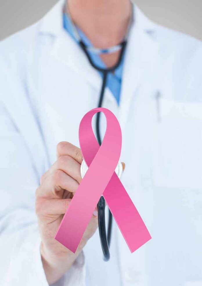 Doctor holding stethoscope with pink ribbon in front