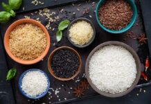 Assorted rice varieties in bowls on a dark tray