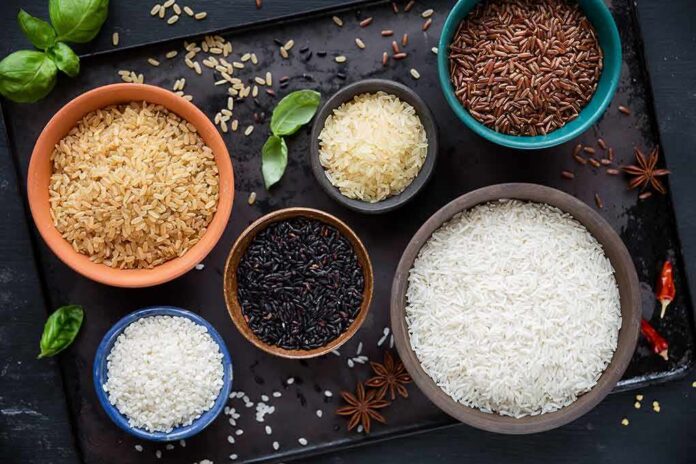 Assorted rice varieties in bowls on a dark tray