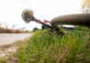 Road bicycle lying on grass beside a rural path
